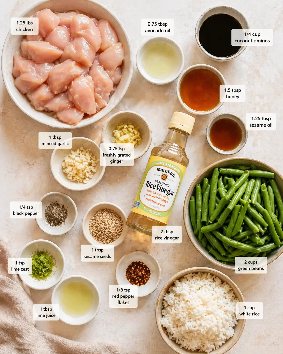Top-down flat lay of cubed chicken, green beans, rice, and labeled sauces for a stir-fry.
