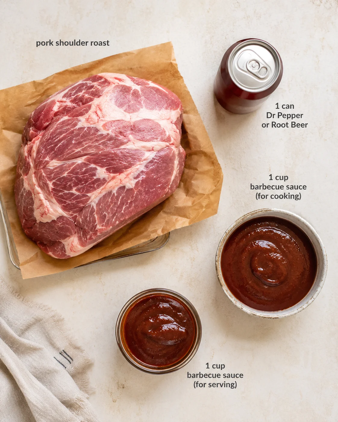 Uncooked pork shoulder roast on parchment with barbecue sauces and a soda can.