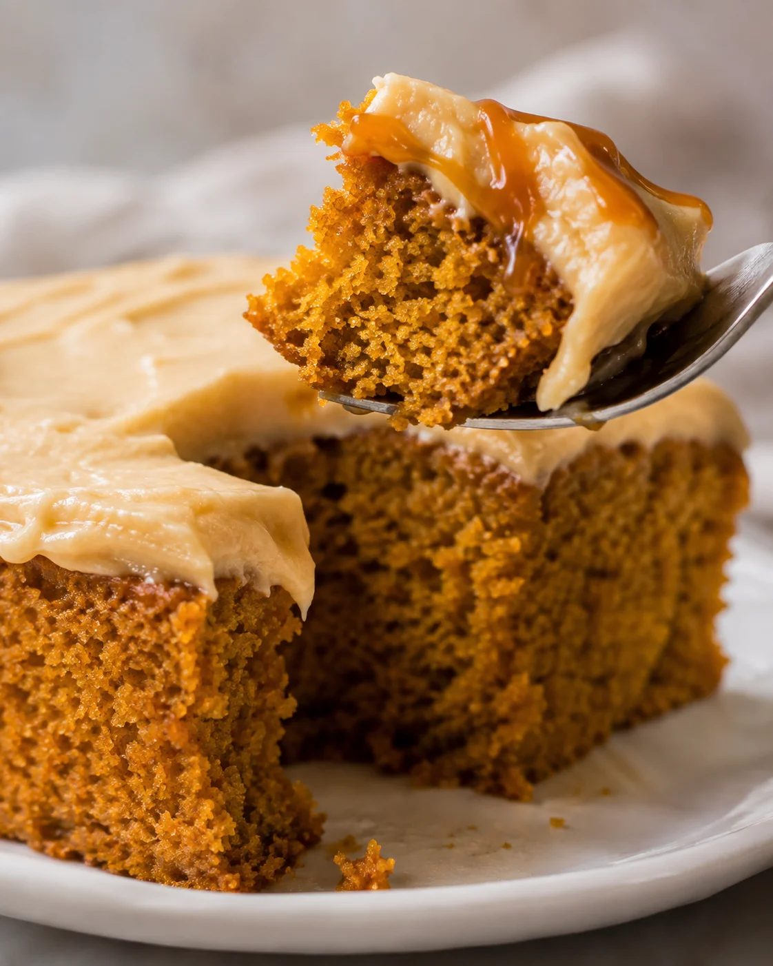 Moist pumpkin cake topped with creamy caramel cream cheese frosting
