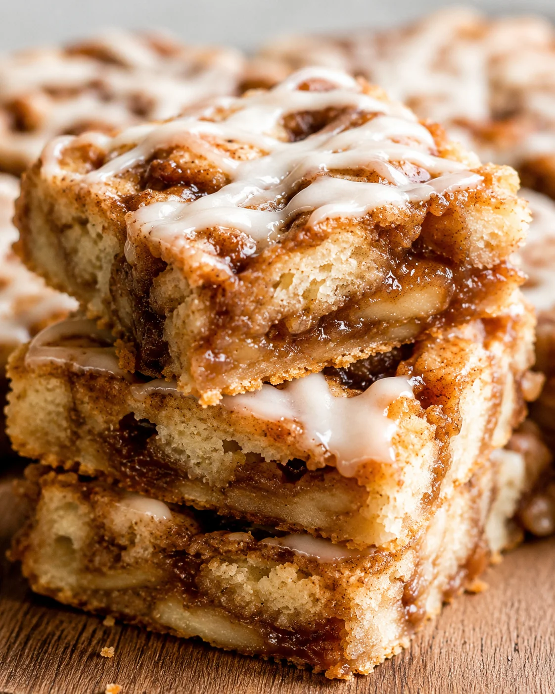 Close-up of moist cinnamon apple cake topped with glaze and walnuts