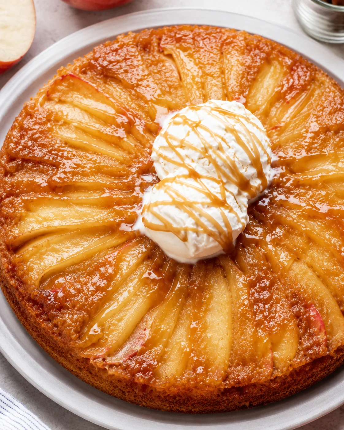 Delicious apple upside down cake with caramelized apples and creamy topping.