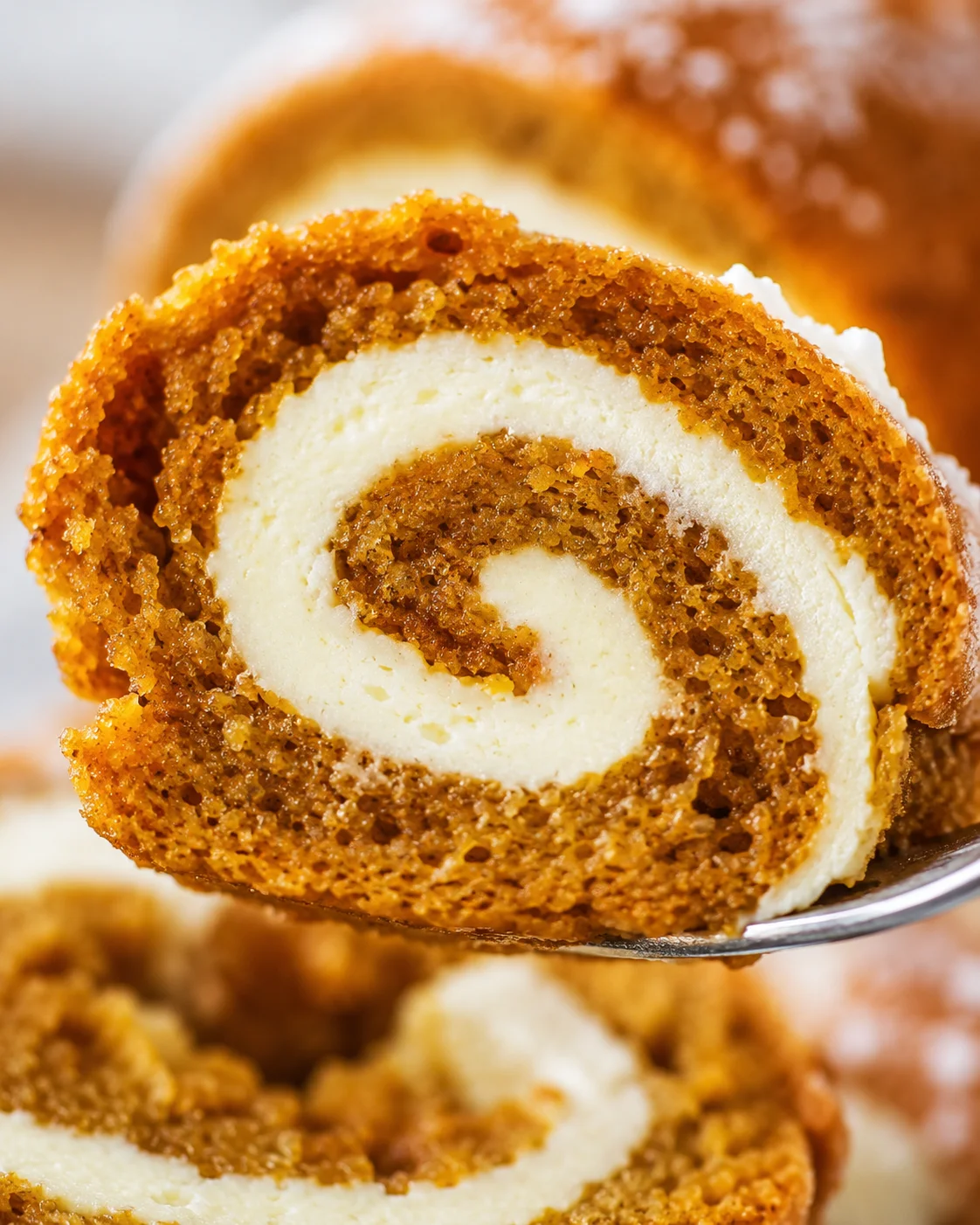 Close-up of a delicious, spiral pumpkin roll with cream cheese filling.