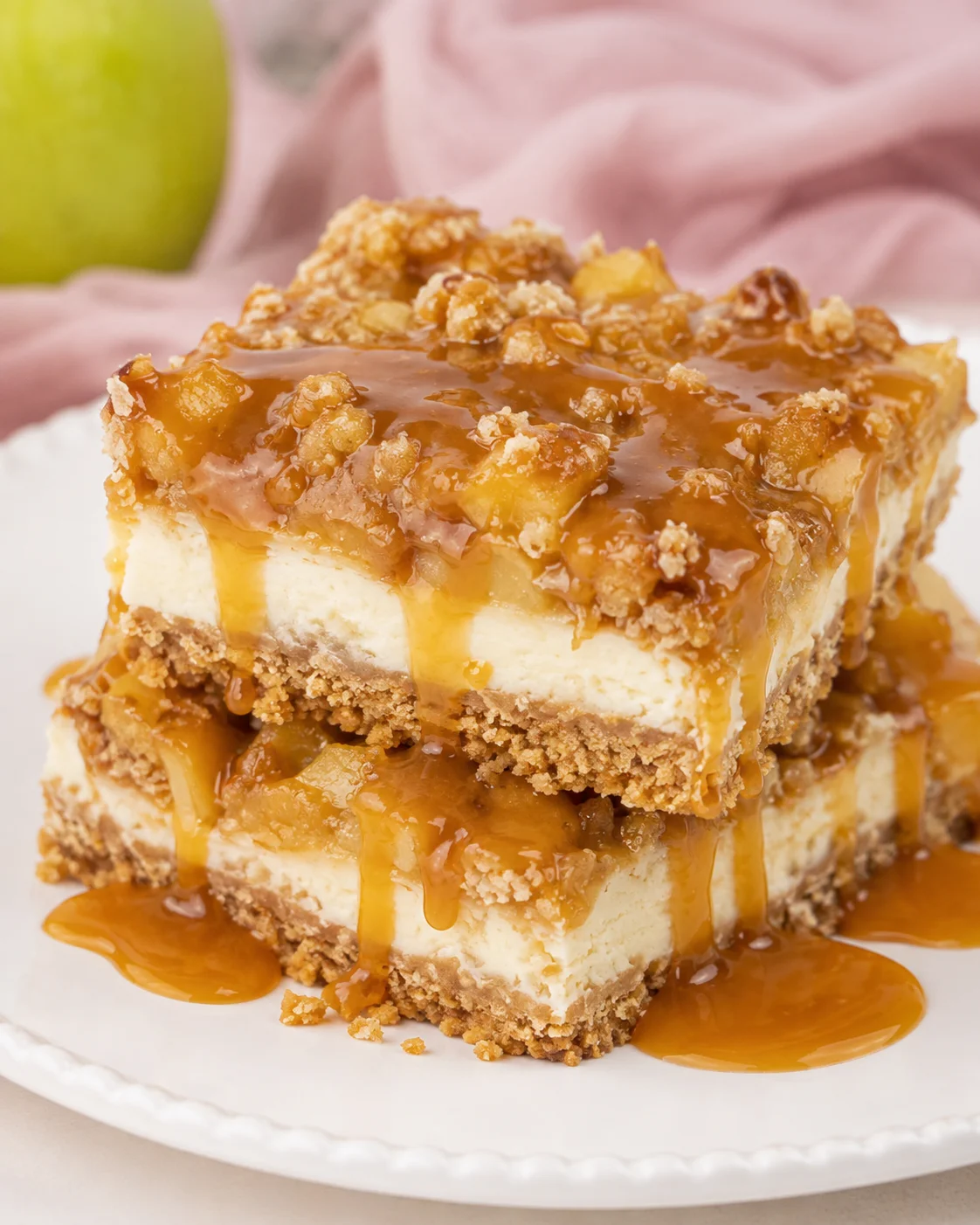 Delicious caramel apple cheesecake bars topped with caramel drizzle and streusel.